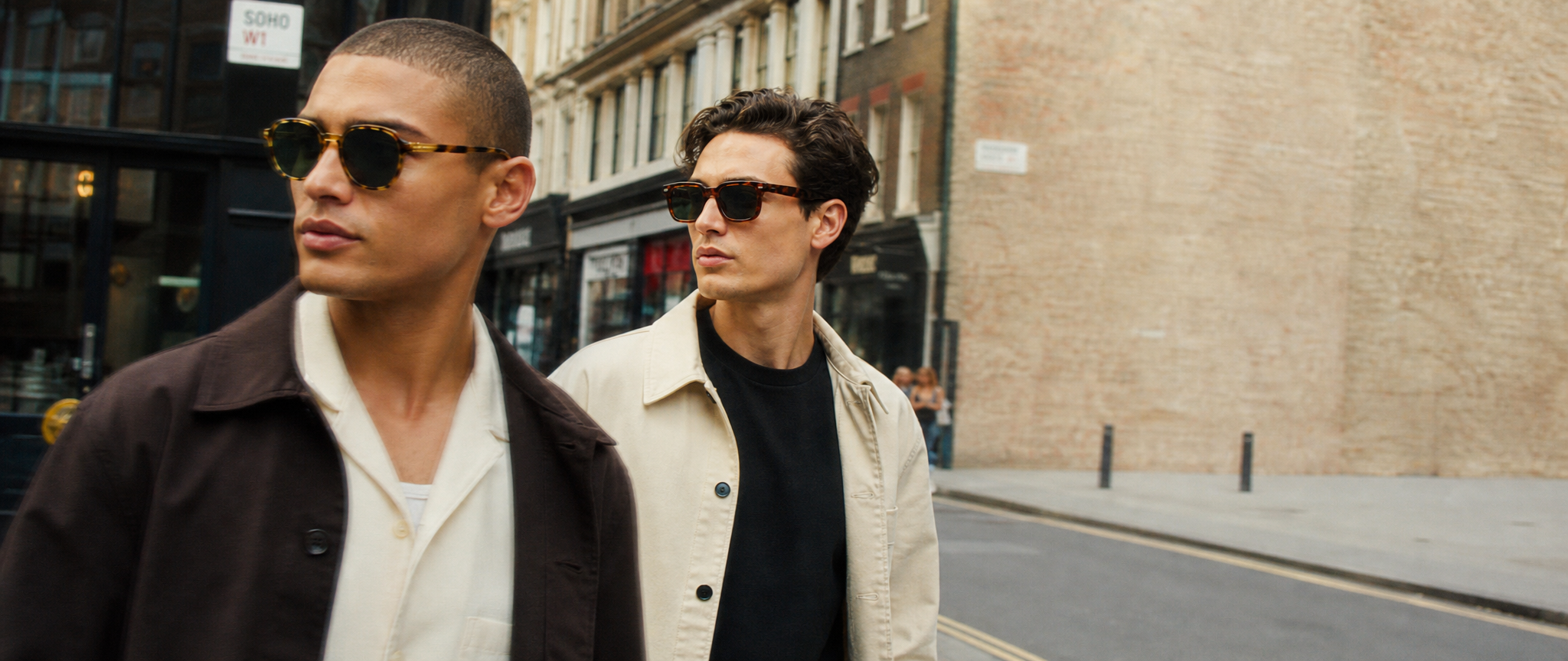 two men walking down a city street for acetate luxury sunglasses