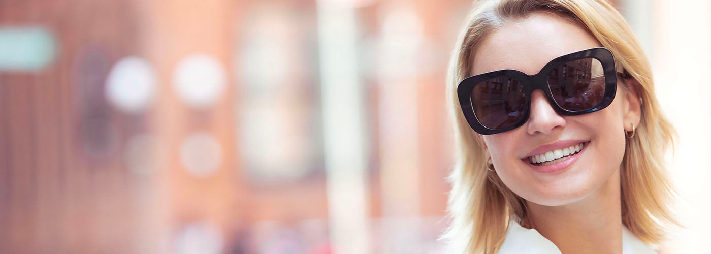 image of a woman wearing oversized square tortoise luxury sunglasses